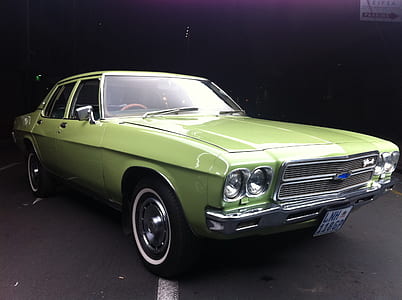 vintage green Chevrolet car on concrete road thumbnail