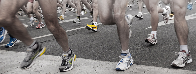 low angle photography of people running on concrete road thumbnail