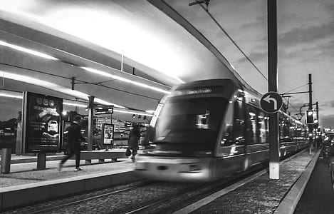 Grayscale Photography of People Near Train thumbnail