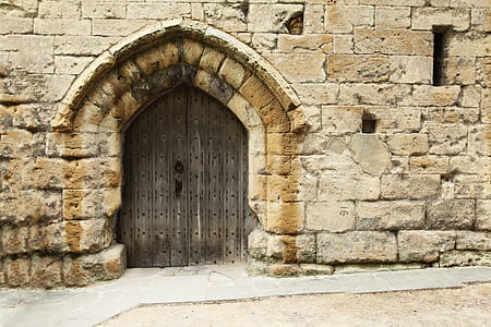 brown wooden double door on brown masonry building thumbnail