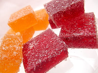 red and orange candies on white surface thumbnail