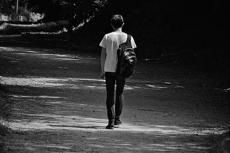 grayscale photo of person wearing black bag thumbnail