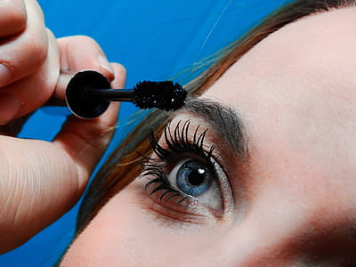 woman putting mascara on her lashes thumbnail