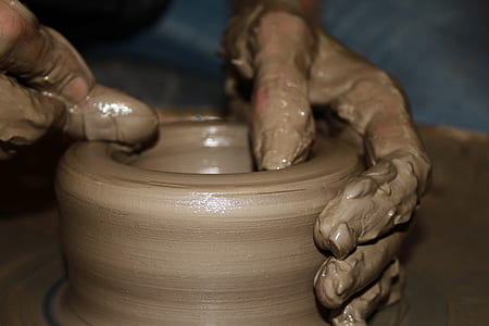 person making clay pot thumbnail