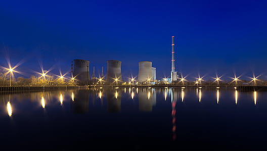 high-rise buildings near body of water under blue sky thumbnail