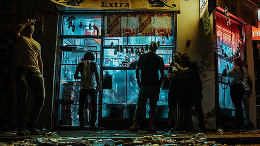 men standing outside store at night thumbnail