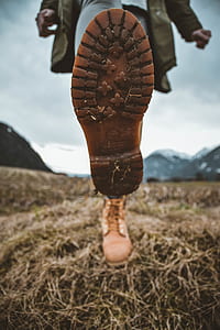 person showing boot sole at daytime thumbnail