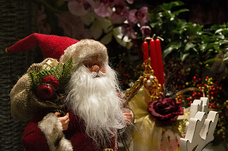 Santa Claus beside 3-pieces of candles inside the room thumbnail