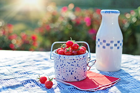 red cherries in white and blue ceramic bucket thumbnail