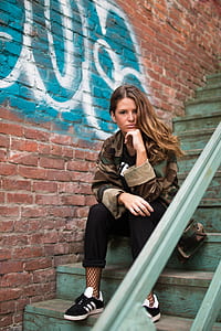 woman sitting on teal wooden stairs thumbnail