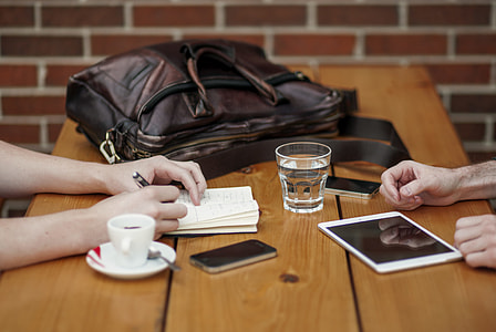 two person with hand on table facing together thumbnail