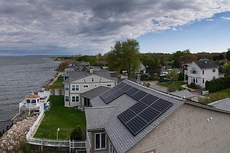 black solar panels on gray roof during daytime thumbnail