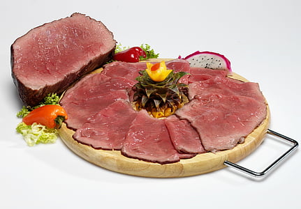 sliced steak on round wooden tray thumbnail