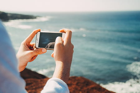 person holding iPhone with black case thumbnail