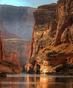 landscape photography of brown cliff and body fo water thumbnail