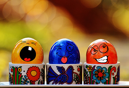 three assorted-color egg decors on cup selective focus photography thumbnail