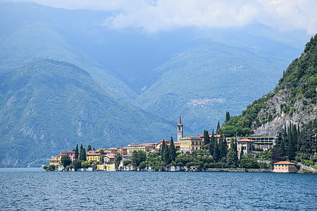 body of water near buildings and mountain thumbnail