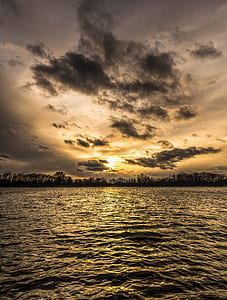 body of water under gray cloudy sky thumbnail