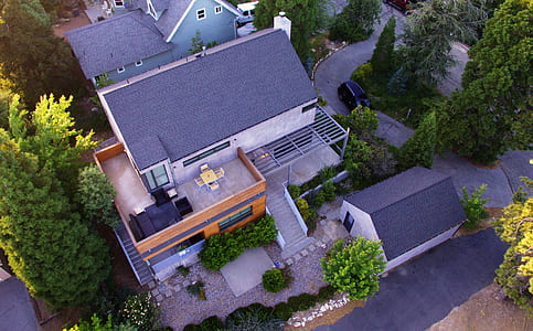 aerial photo of gray and brown house near green leaf tree thumbnail