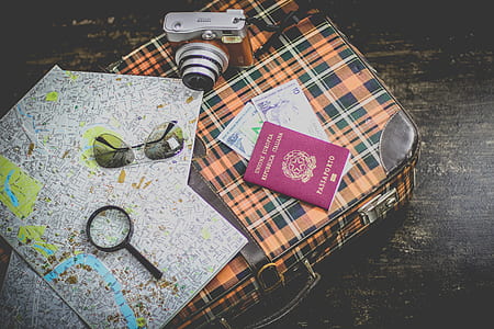 flat lay photography of red compact camera near sunglasses thumbnail