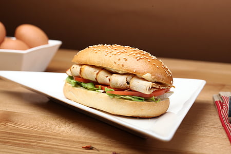hamburger on triangle plate on brown surface thumbnail