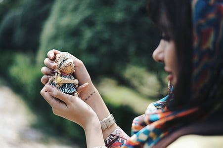 woman holding blue toy thumbnail