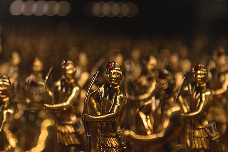 male holding bow gold-colored figurine lot thumbnail