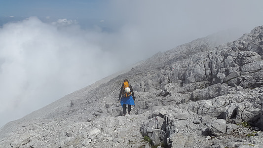 person standing on rock formation during daytime thumbnail