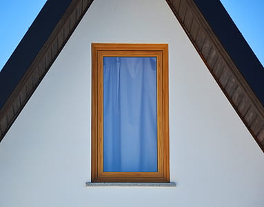 blue curtain as seen through window with wooden frame thumbnail