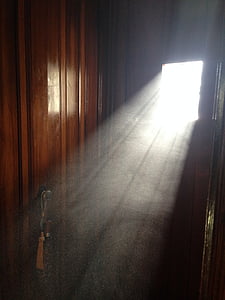 brown wooden door with white beam of sun thumbnail