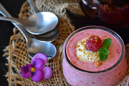 strawberry dessert on clear glass cup beside stainless steel spoons thumbnail