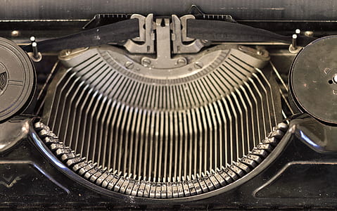 black and gray typewriter with ribbon thumbnail