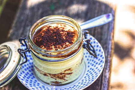 clear canister jar on white saucer shallow focus photography thumbnail