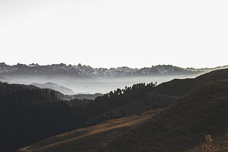 landscape photography of mountains and body of water thumbnail