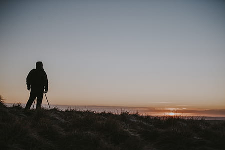 man standing on mountain top during sunset thumbnail
