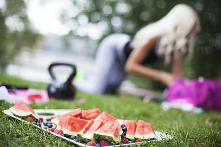 sliced watermelons and berries on tray on green field thumbnail