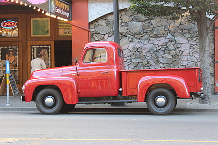 red single cab pickup truck parked beside sidewalk near tree thumbnail