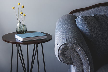 blue book on round brown wooden coffee table thumbnail