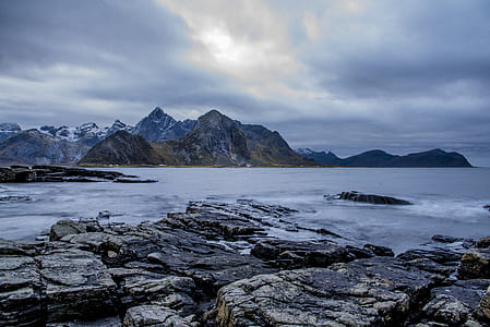 brown rocky mountains near body of water thumbnail