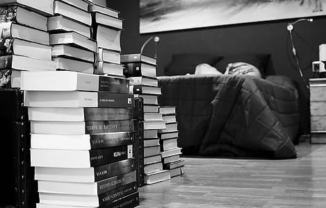 assorted books near bed thumbnail