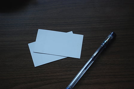 blue pen beside two empty papers thumbnail