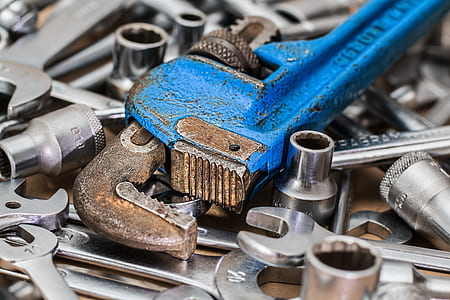 closeup photo of blue and brown steel pipe wrech thumbnail