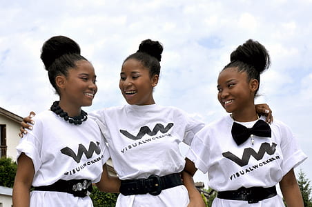 three women standing beside each other while wearing the same outfits thumbnail