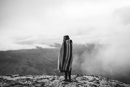 woman standing on mountain cliff thumbnail
