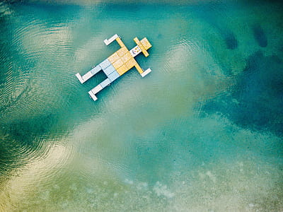 man with yellow hat floating on body of water illustration thumbnail