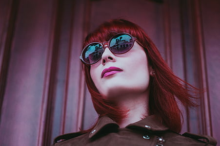 woman standing in front of red wall thumbnail