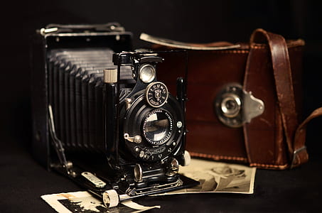 black folding camera with brown leather bag thumbnail