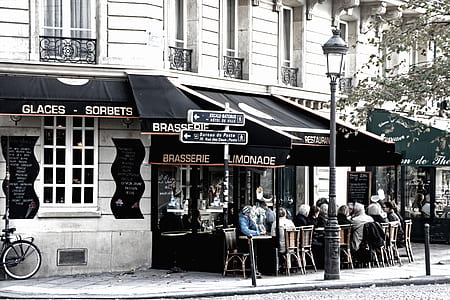 crowd of people sitting in front of store during daytime thumbnail