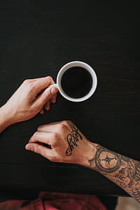 person holding filled white cup thumbnail