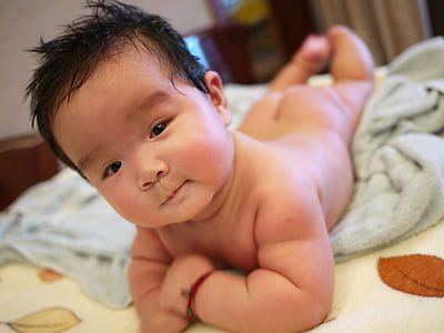photography of naked baby on gray towel thumbnail